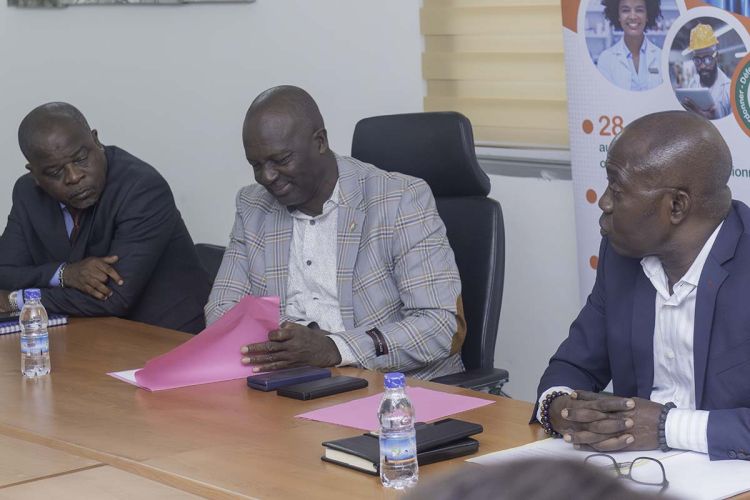 3 personne sur un table de séance.
